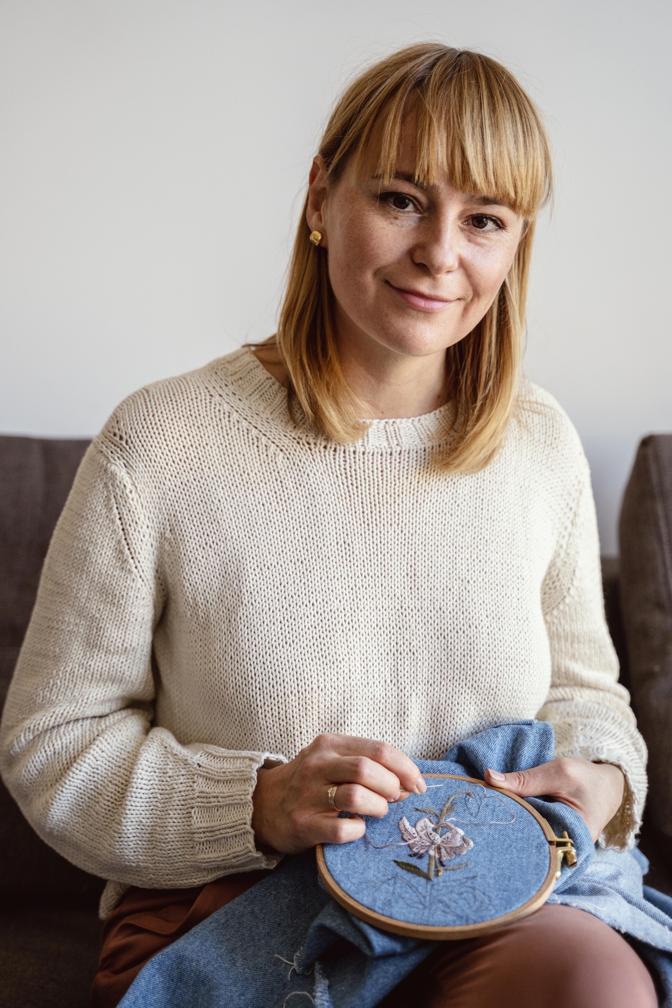 portrait of studio founder with needle and hoop